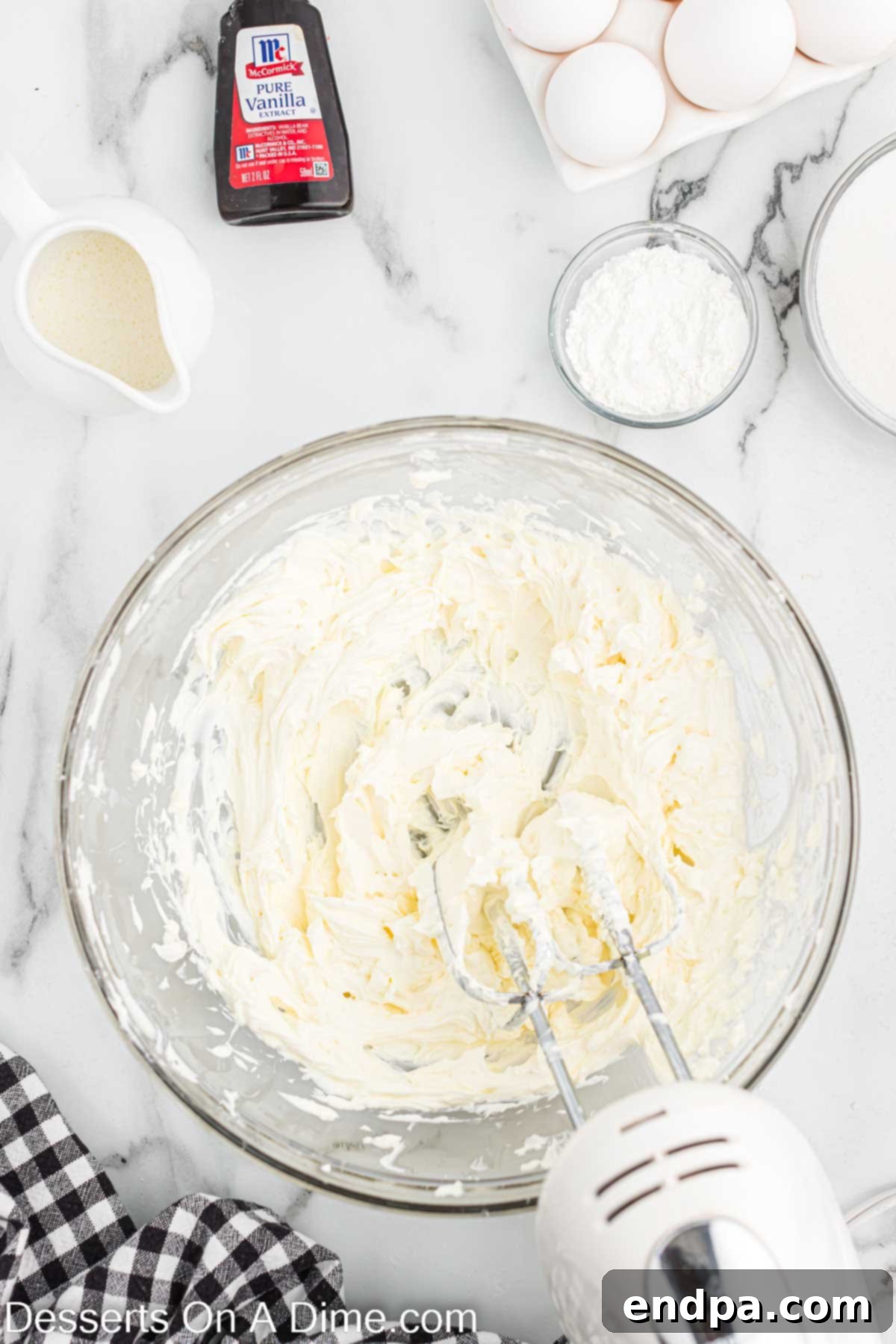 Cream cheese frosting being mixed in a bowl, showing its smooth, creamy texture.
