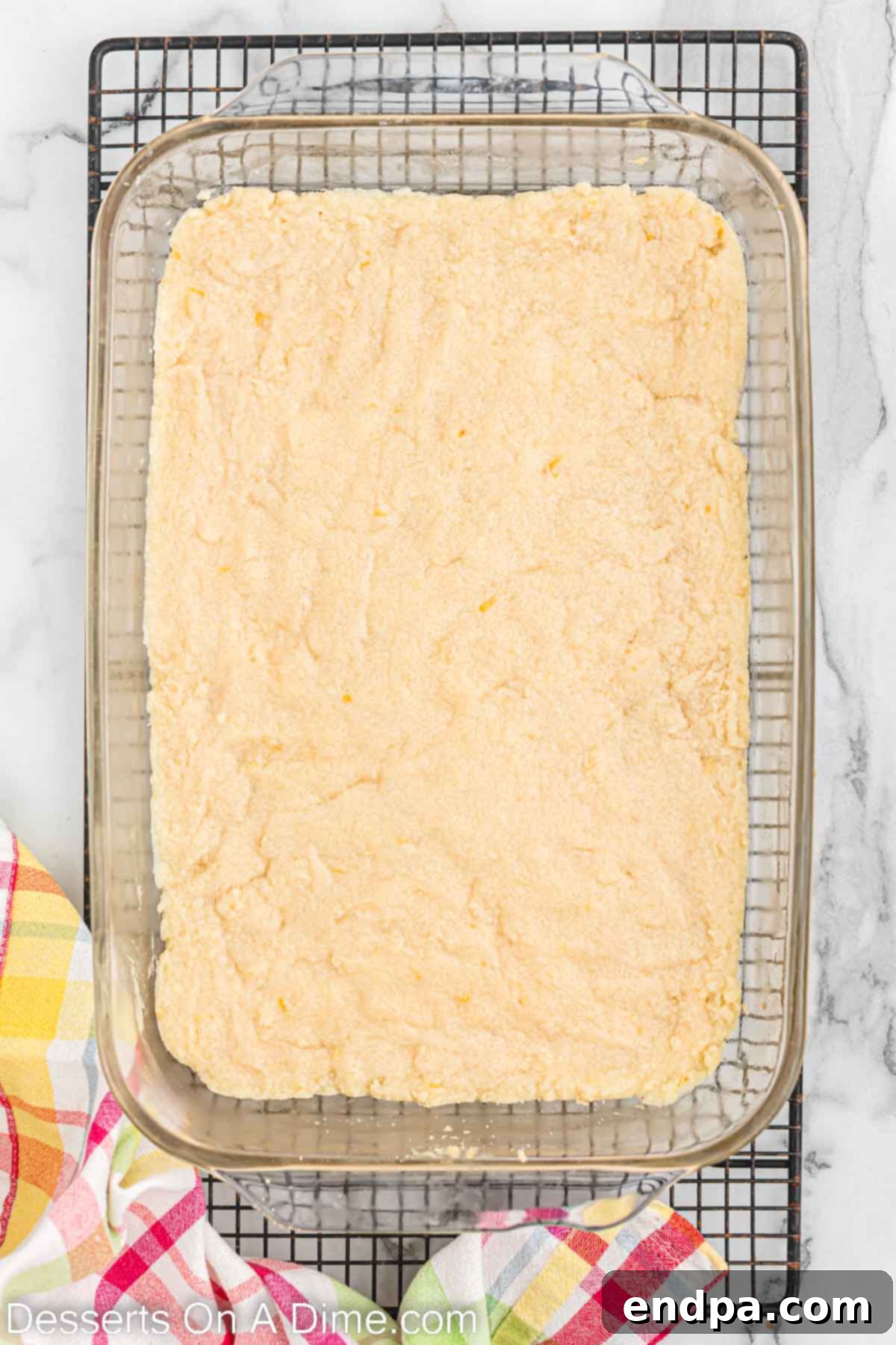 Cookie dough pressed evenly into a 9x13 inch baking pan.