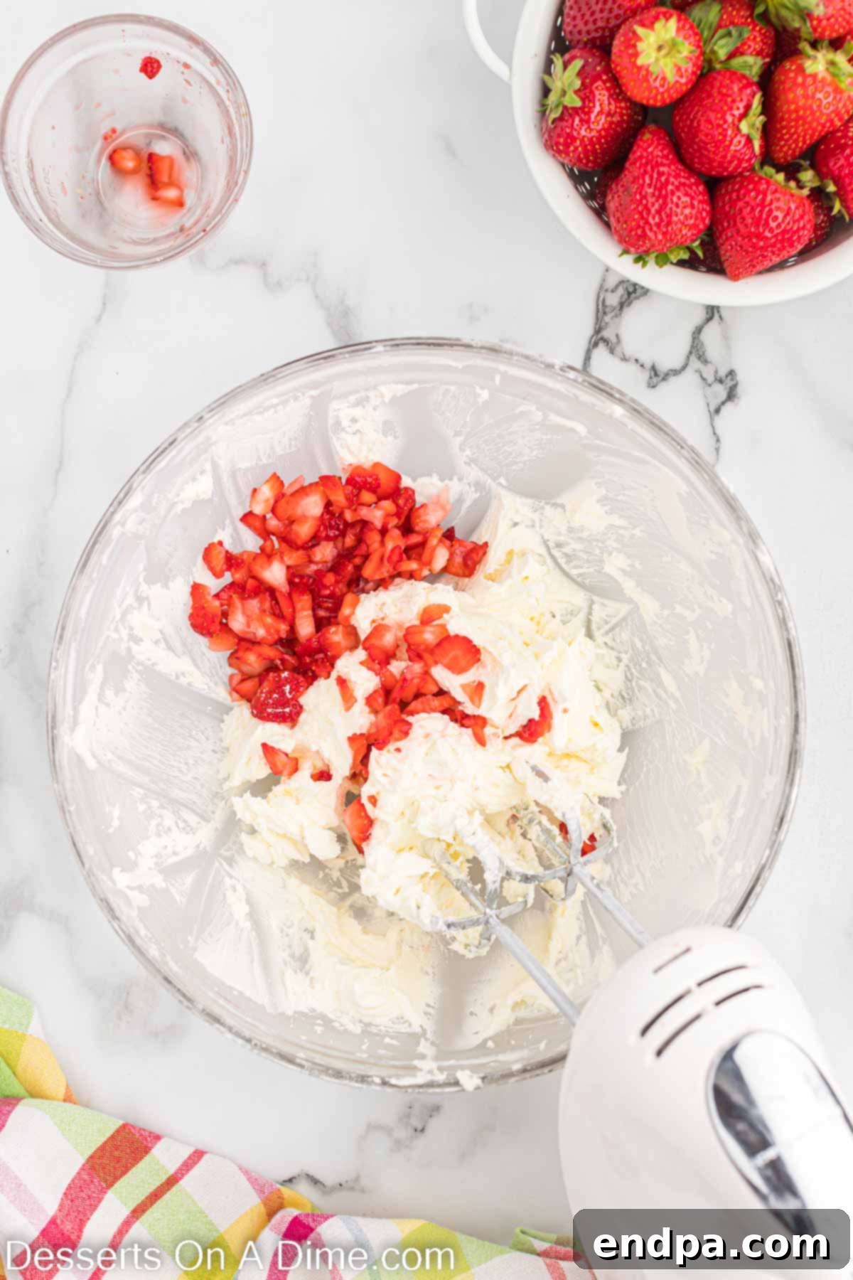 Softened butter and powdered sugar being creamed together for frosting.