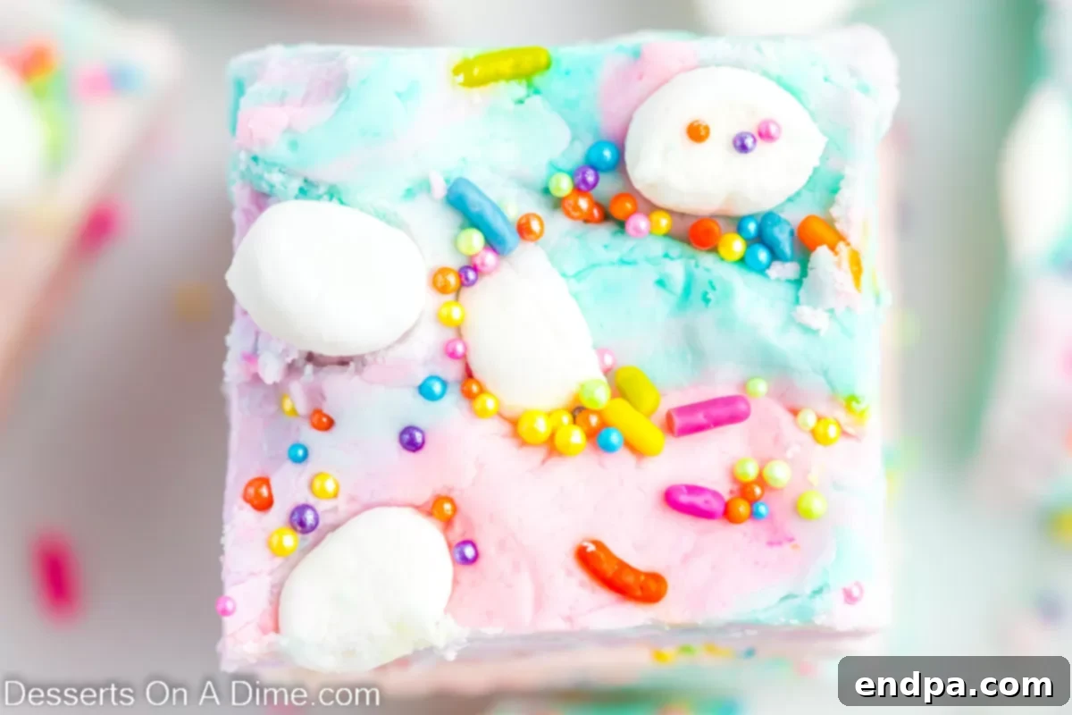 Enchanted Unicorn Swirl Fudge 2 Beautifully cut squares of Unicorn Fudge adorned with rainbow sprinkles, ready to be enjoyed.