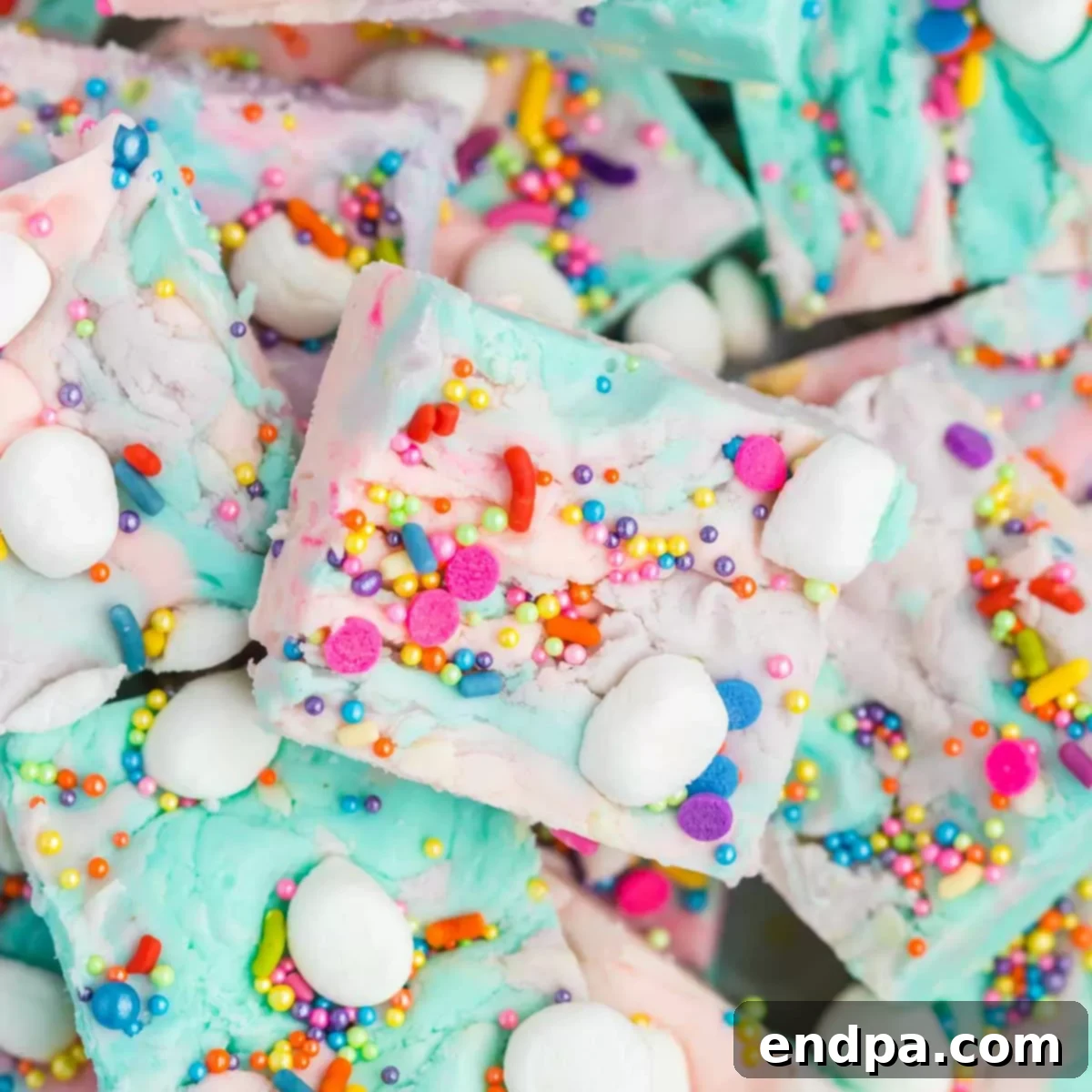 Enchanted Unicorn Swirl Fudge 11 A pile of colorful fudge with sprinkles and marshmallows.