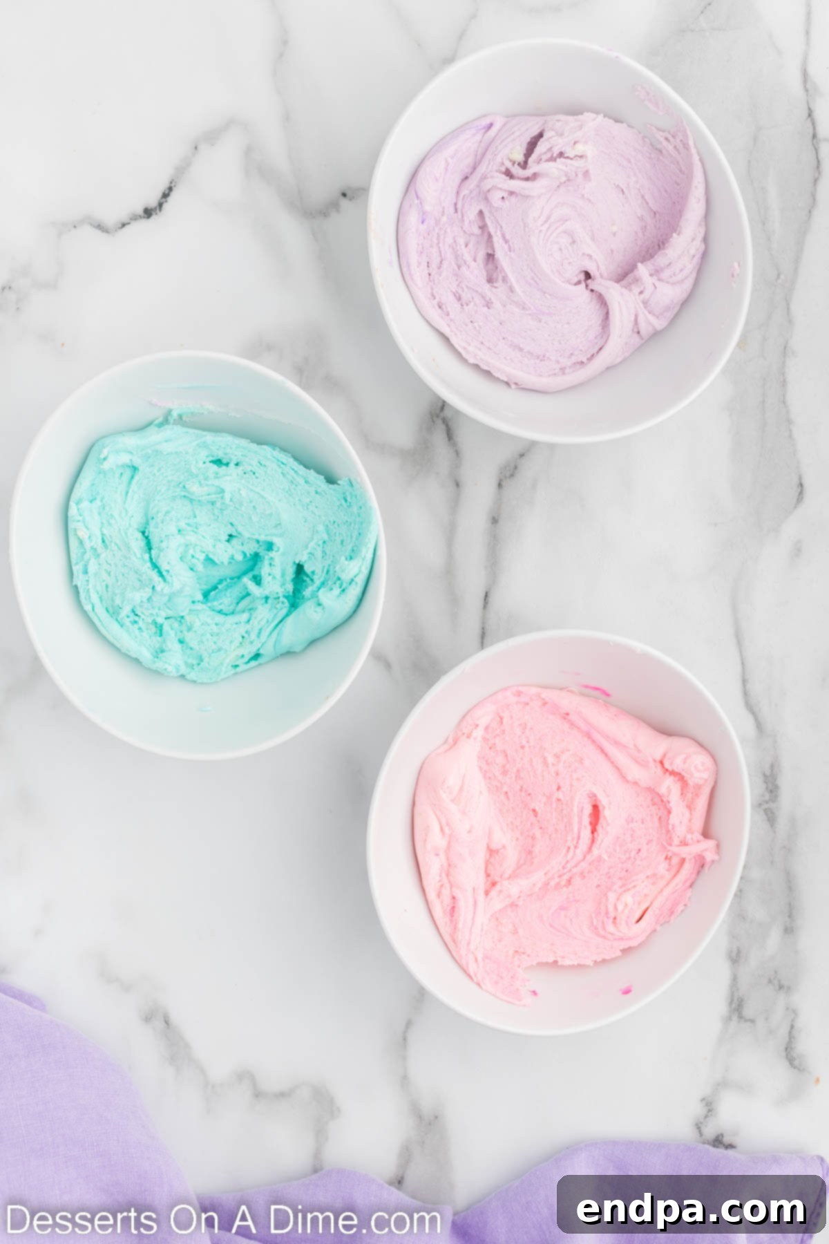 Enchanted Unicorn Swirl Fudge 6 Three separate bowls, each containing a portion of fudge mixture dyed with pink, purple, and blue food coloring.