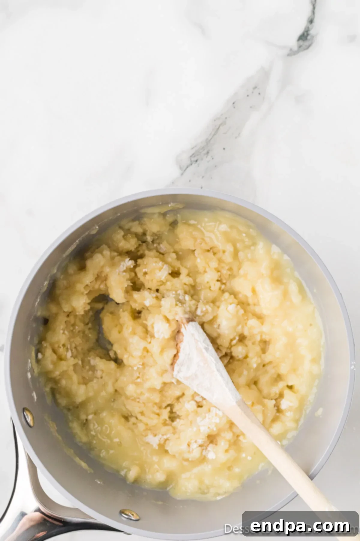 Classic Italian Zeppole Recipe 4 Flour mixture in pan being combined.