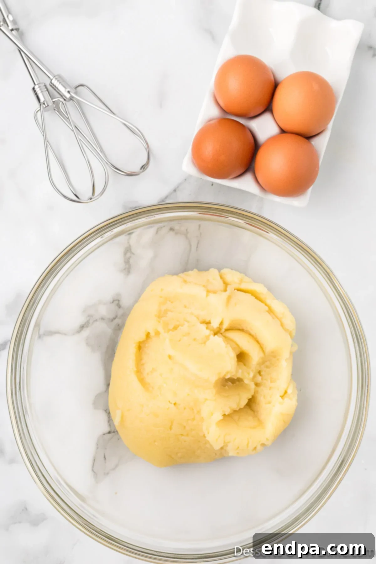 Classic Italian Zeppole Recipe 5 Flour mixture cooling in bowl.