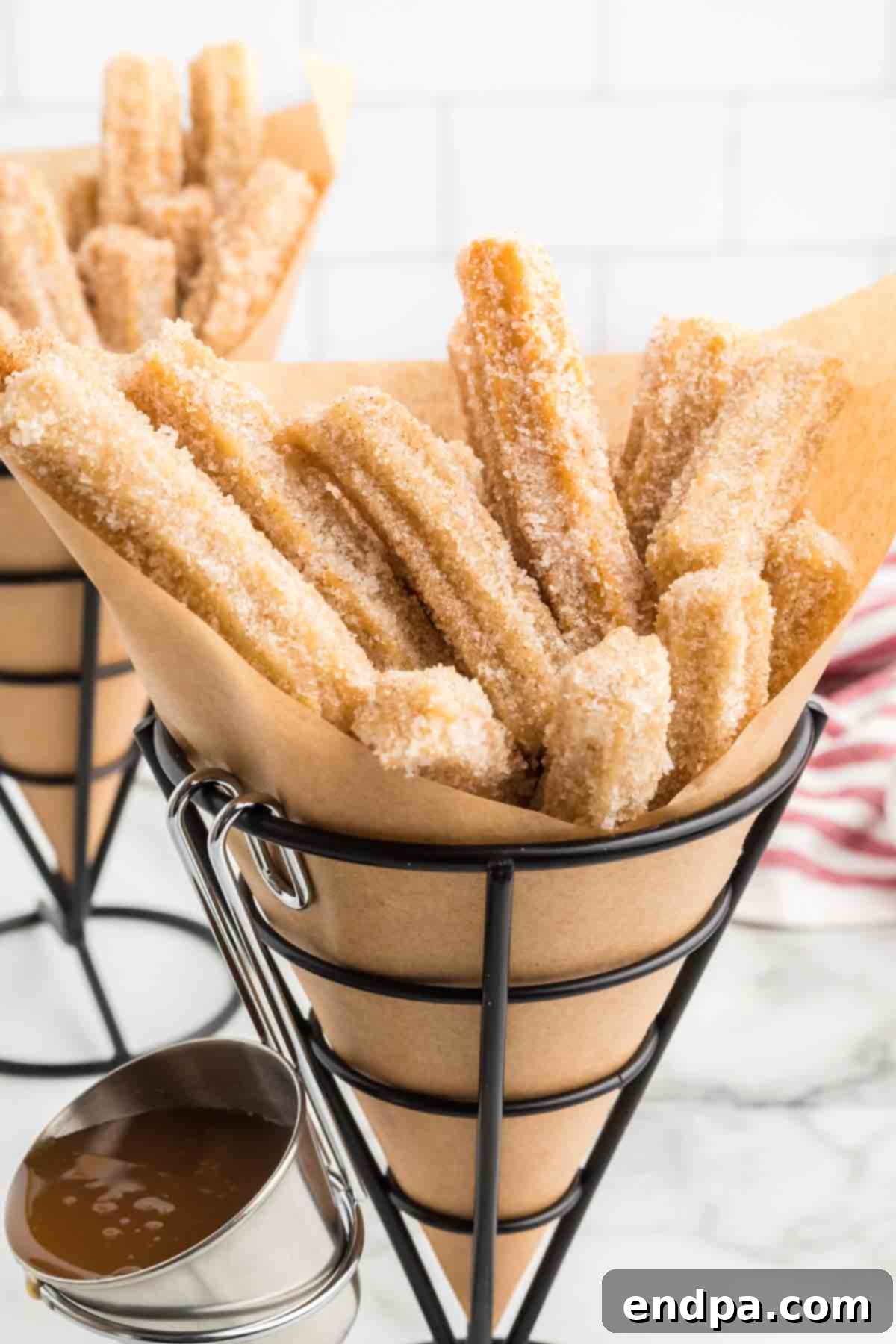 Churro bites arranged in small individual serving cups.