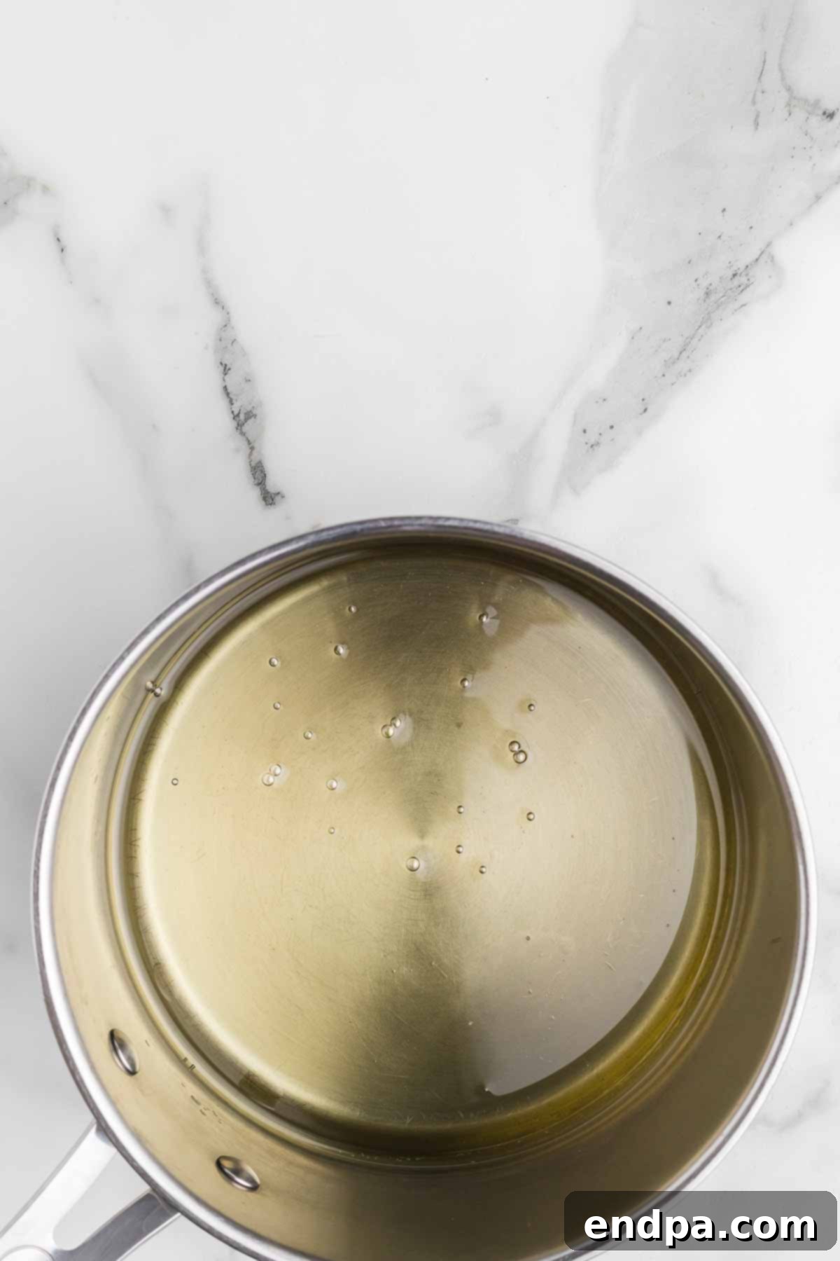 Vegetable oil heating in a large pot on the stove.