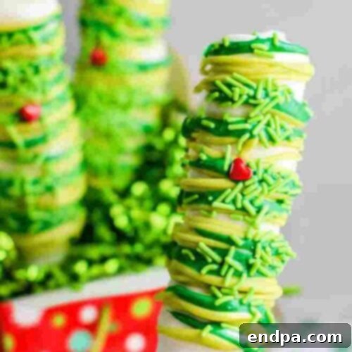 Grinchmas Dessert Delights 8 Grinch Marshmallow Pops on sticks, decorated with green and red.