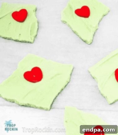 Grinchmas Dessert Delights 17 Grinch Bark, white chocolate with green swirls and red heart sprinkles.