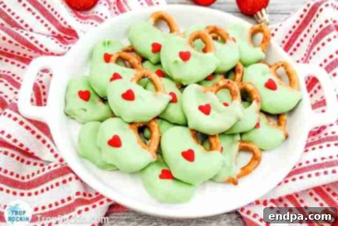 Grinchmas Dessert Delights 19 Grinch Pretzels, green-coated rods with red heart sprinkles.