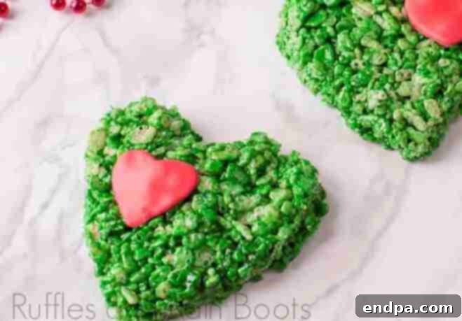 Grinchmas Dessert Delights 22 Heart-shaped Grinch Rice Krispies treats with a red candy heart.