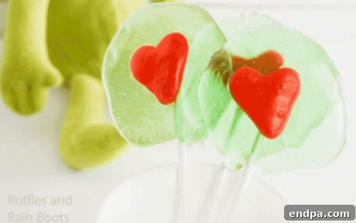 Grinchmas Dessert Delights 26 Grinch Lollipop Recipe, showing green lollipops with a Grinch face.