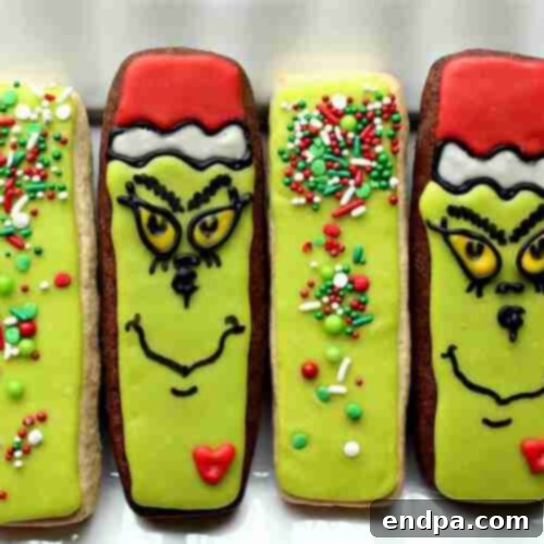 Grinchmas Dessert Delights 28 Decorated Grinch Cookies, shaped and frosted with green and red designs.