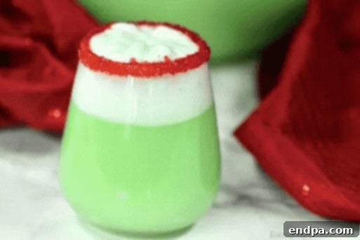 Grinchmas Dessert Delights 5 A glass of green Grinch punch with sherbet and a straw.