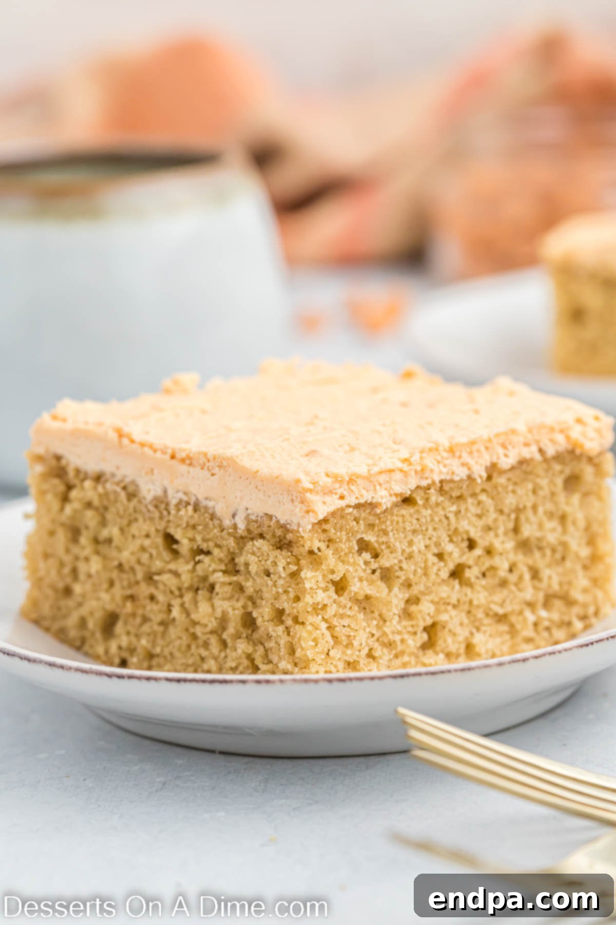 Butterscotch Bliss Cake 2 A slice of moist butterscotch cake topped with creamy frosting on a plate, ready to be enjoyed.