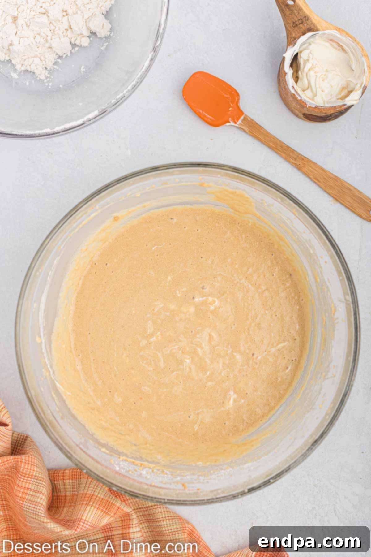 Butterscotch Bliss Cake 5 Wet ingredients (creamed butter, sugar, eggs, milk, vanilla) mixed together in a bowl.