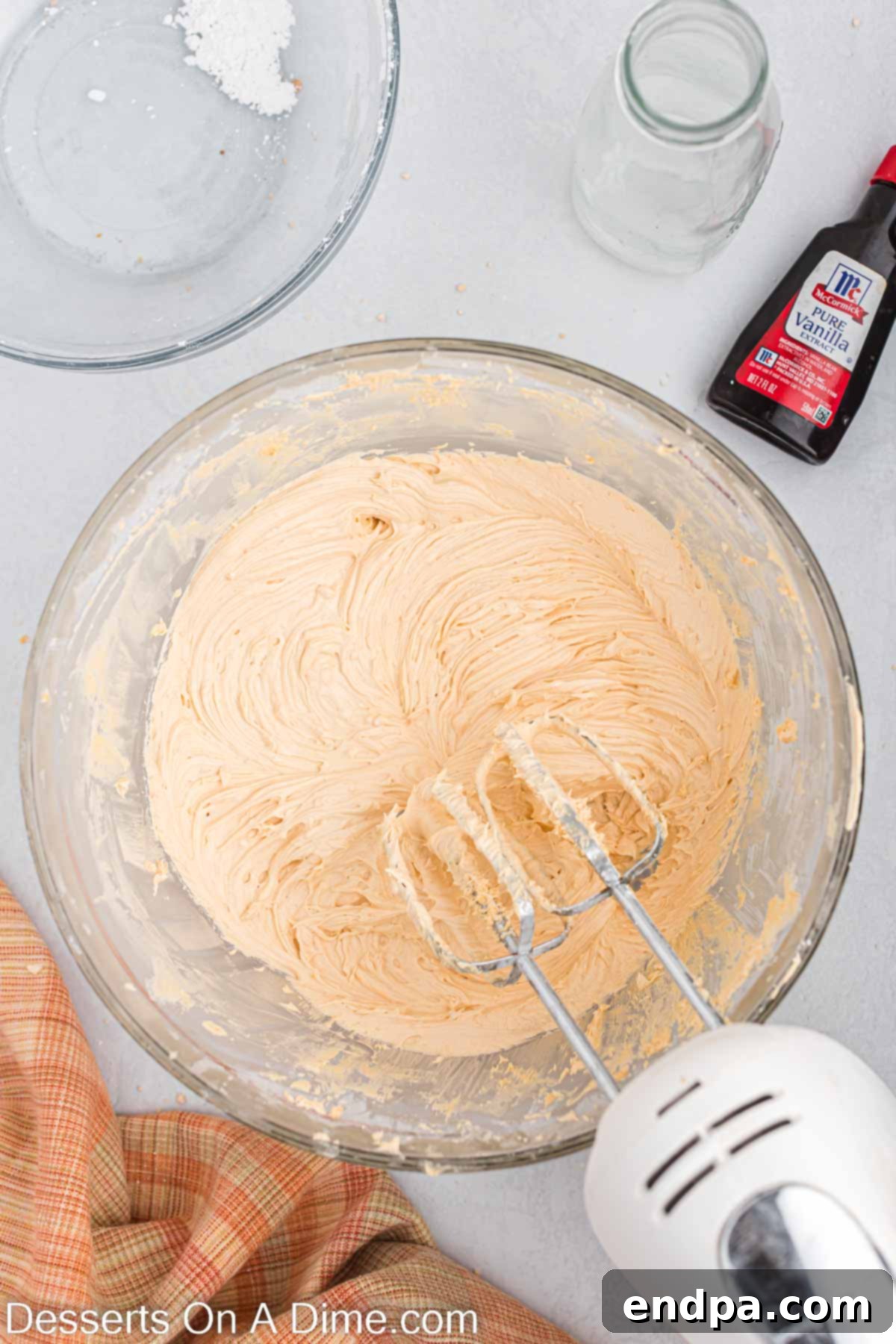 Butterscotch Bliss Cake 8 Softened butter and powdered sugar being added to melted butterscotch chips for frosting.