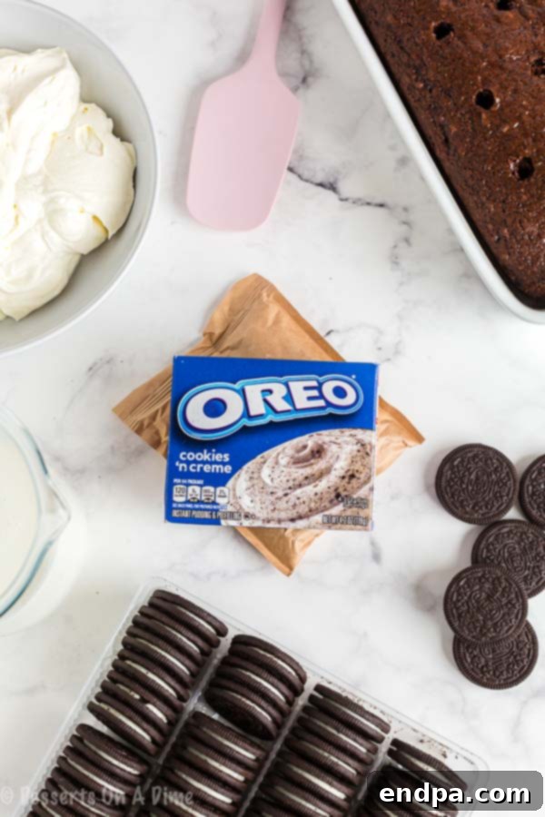 Ingredients needed for Oreo Poke Cake: chocolate cake mix, Oreo instant pudding mix, milk, whipped topping, and Oreo cookies for garnish.