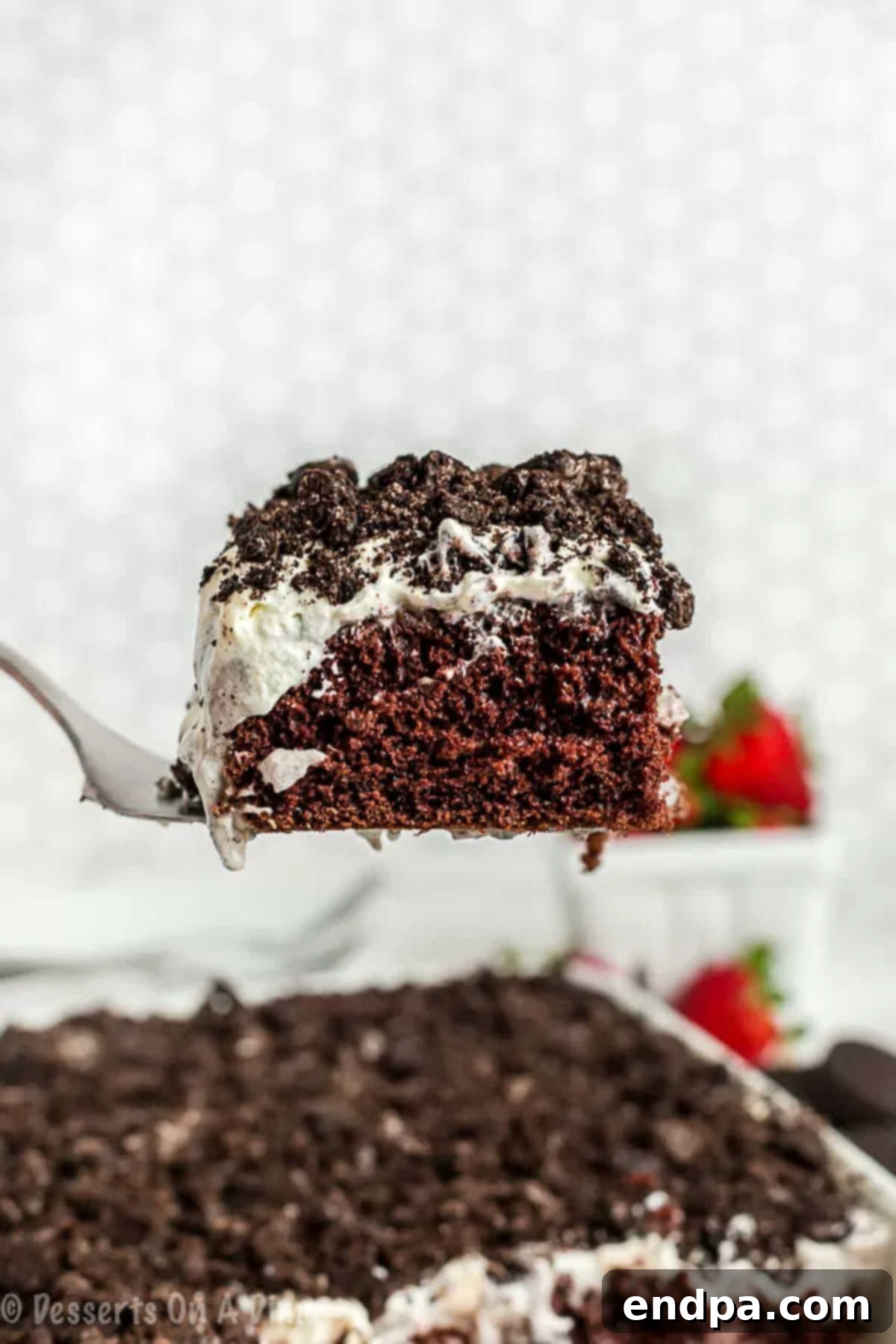 Oreo Pudding Cake being sliced and served. 