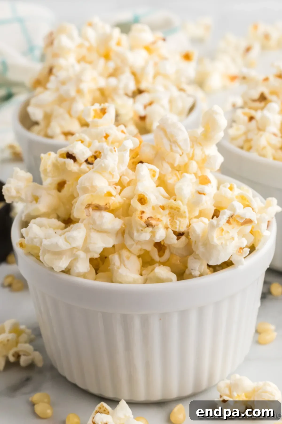 Sweet & Salty Kettle Corn 2 Crispy homemade Kettle Corn served in elegant white bowls.