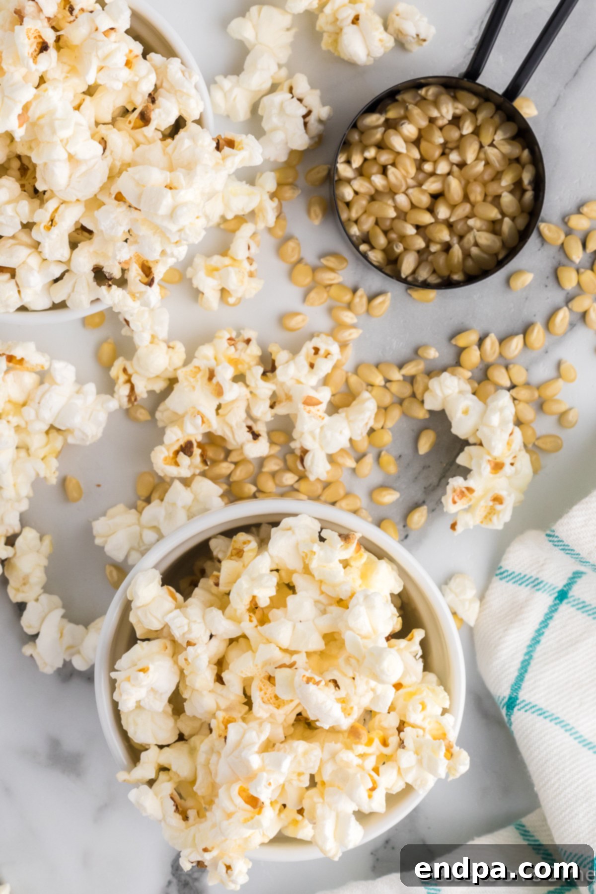 Sweet & Salty Kettle Corn 8 Bowls filled with popcorn kernels and a separate bowl of freshly popped kettle corn.