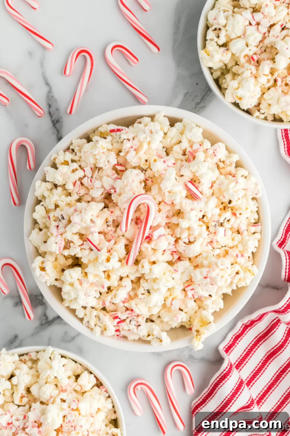 Peppermint Pop Crunch 2 A beautifully arranged bowl of Candy Cane Popcorn, ready to be enjoyed during the holiday season.