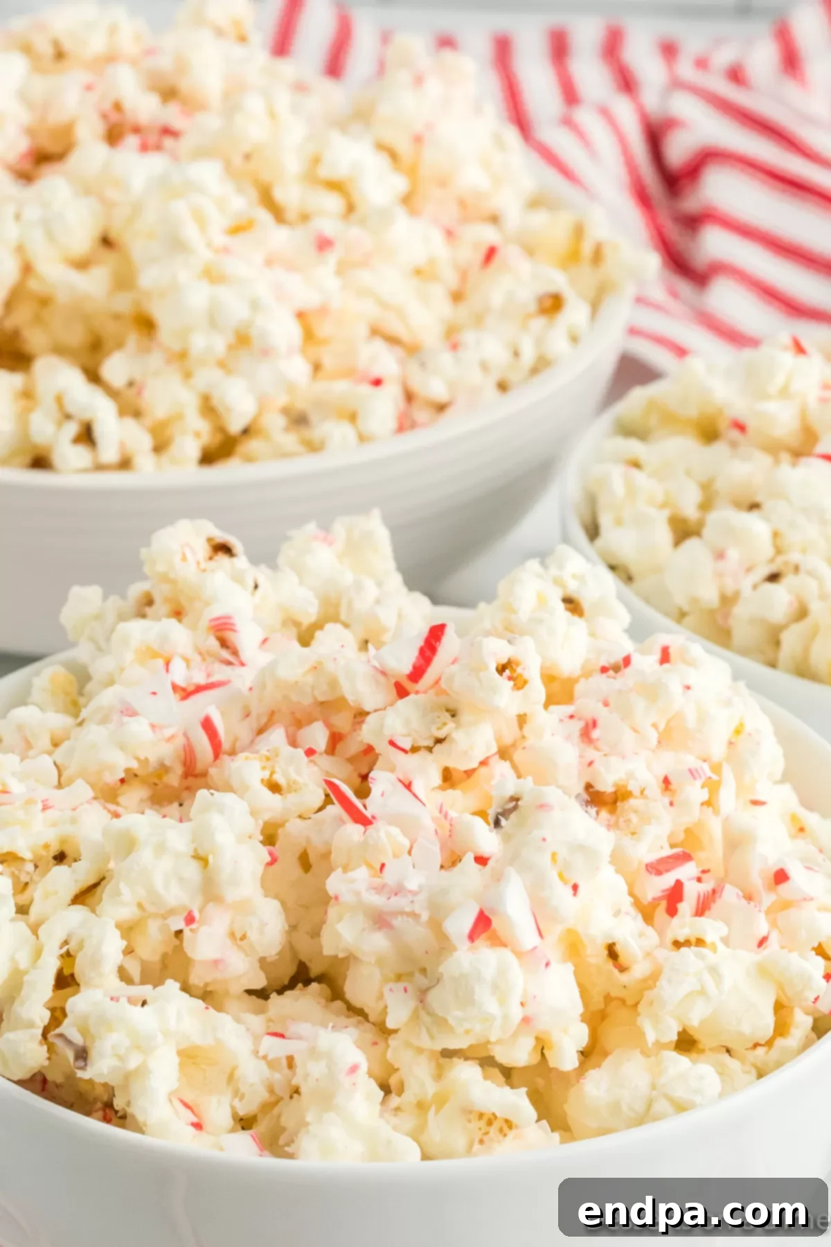 Peppermint Pop Crunch 8 A large bowl filled with delicious Candy Cane Popcorn, ready for a holiday gathering.