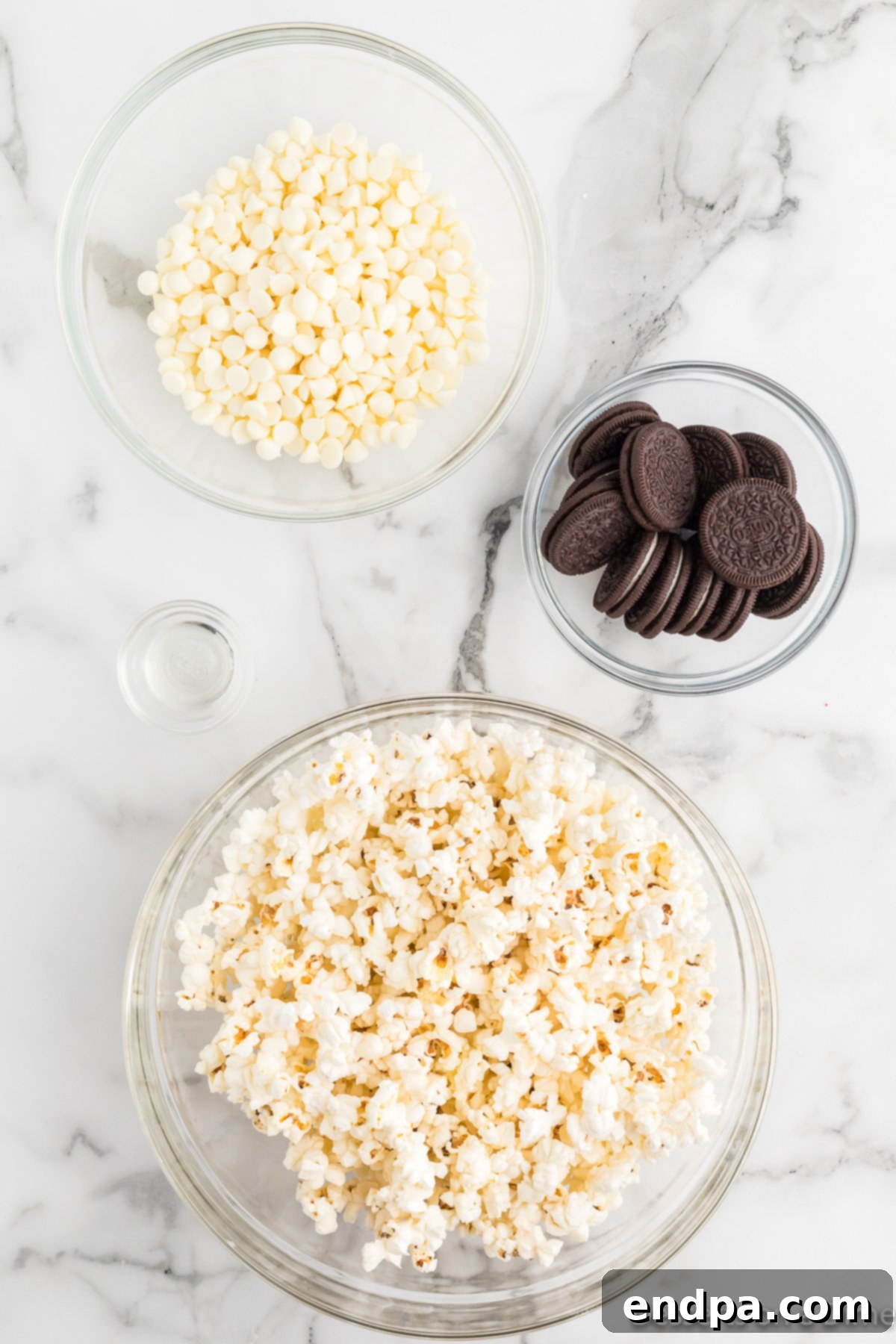 Oreo Popcorn Crunch 3 Ingredients for Oreo popcorn recipe - popcorn, white chocolate chips, oreo cookies.