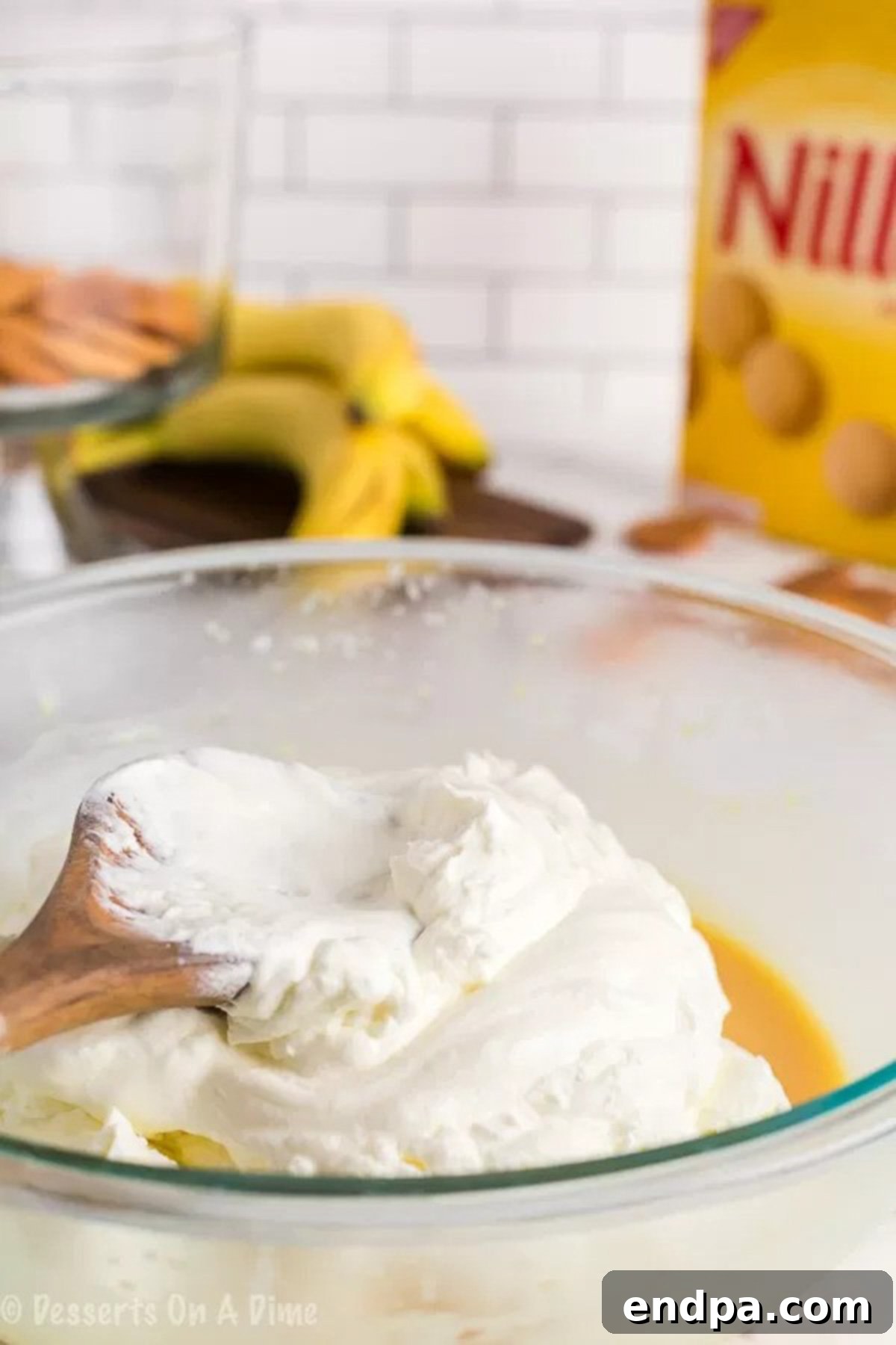 Close-up image of stiff peaks forming in whipped heavy cream, ready to be folded into the pudding mixture.
