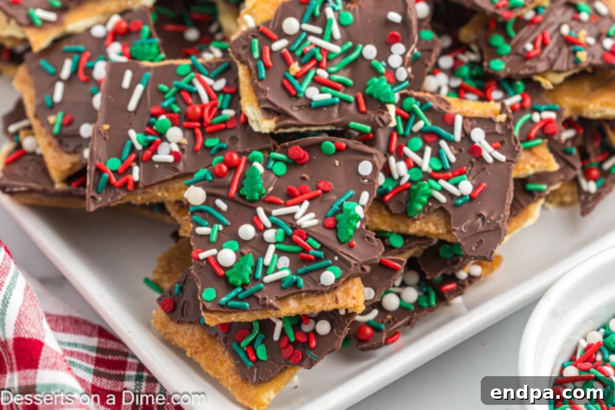 Delicious Christmas crack broken into irregular pieces and elegantly arranged on a festive platter, ready to be served at a holiday gathering.