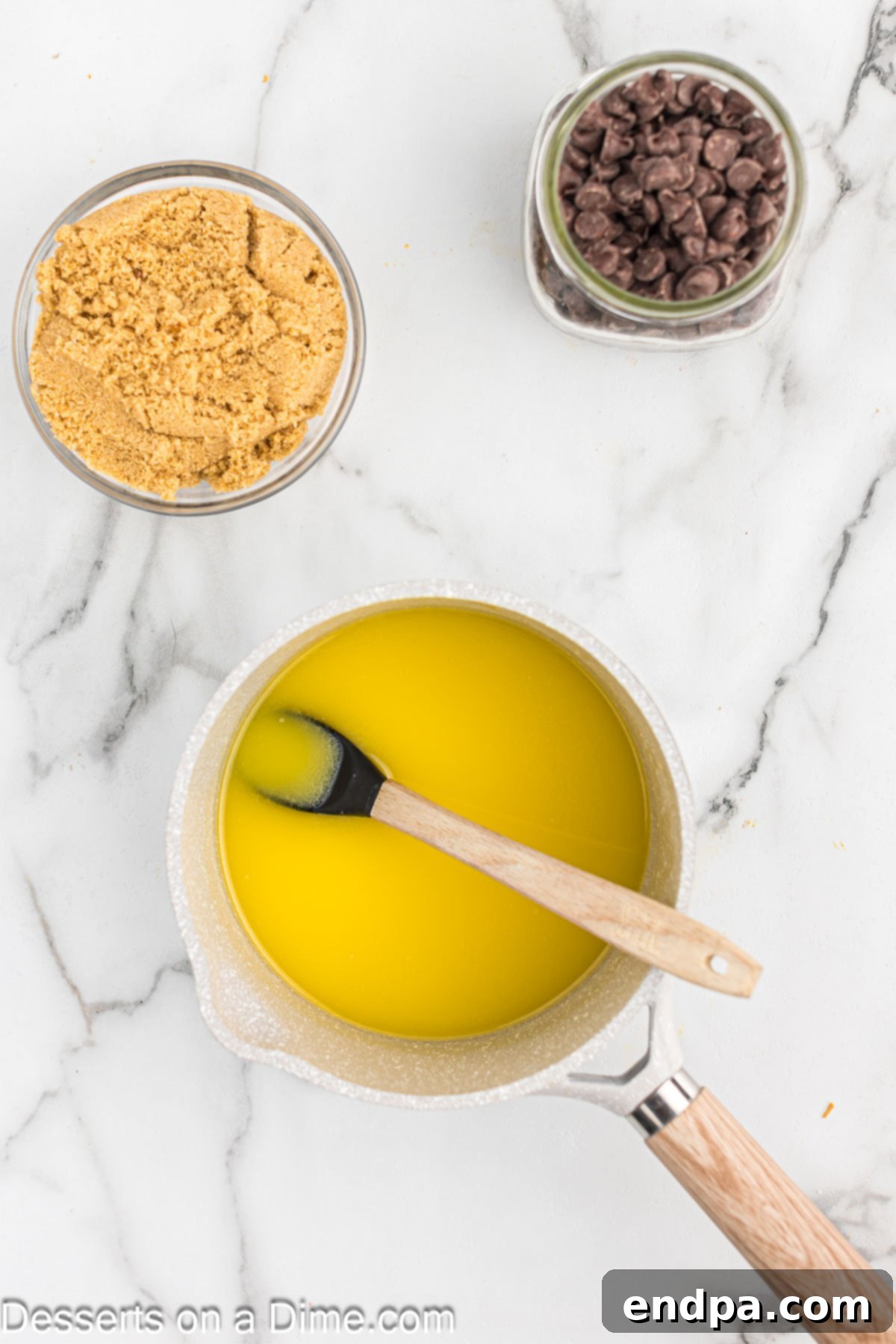 Butter melting gently in a small saucepan over low-medium heat on a stovetop, starting the toffee base for the Christmas Crack recipe.