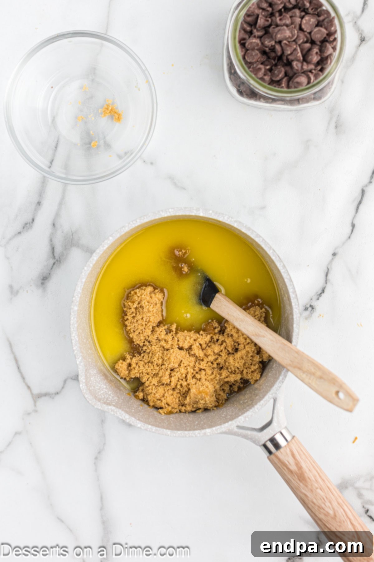 Brown sugar being added to the melted butter in a saucepan, ready to be stirred and combined to create the rich toffee mixture.