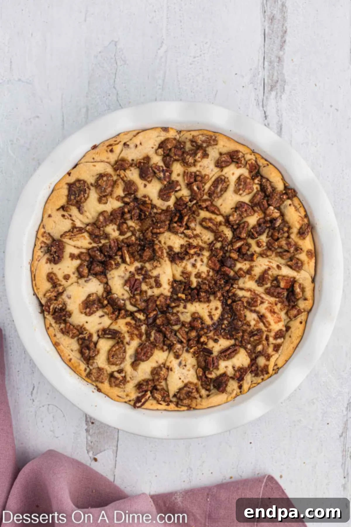 Homemade Cinnamon Roll Pie 12 A freshly baked Cinnamon Roll Pie, golden brown and cooling on a wire rack, before glazing.