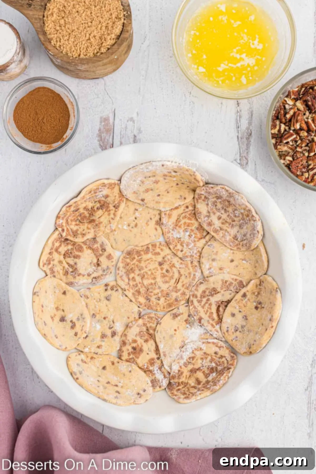 Homemade Cinnamon Roll Pie 6 Cinnamon roll halves carefully arranged and pressed into the bottom of a pie plate, forming a continuous crust.