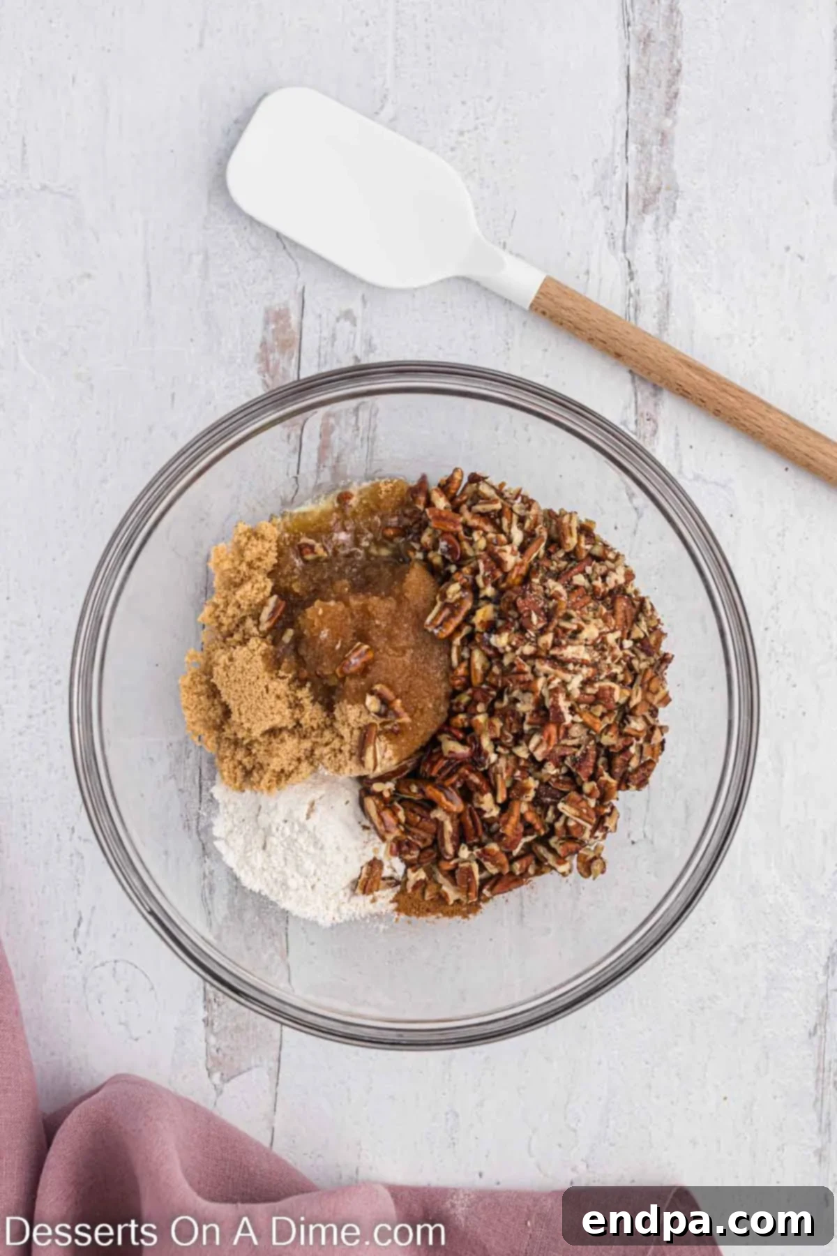 Homemade Cinnamon Roll Pie 7 A mixing bowl containing a rich brown sugar mixture, showing its soft, crumbly texture before other ingredients are added.