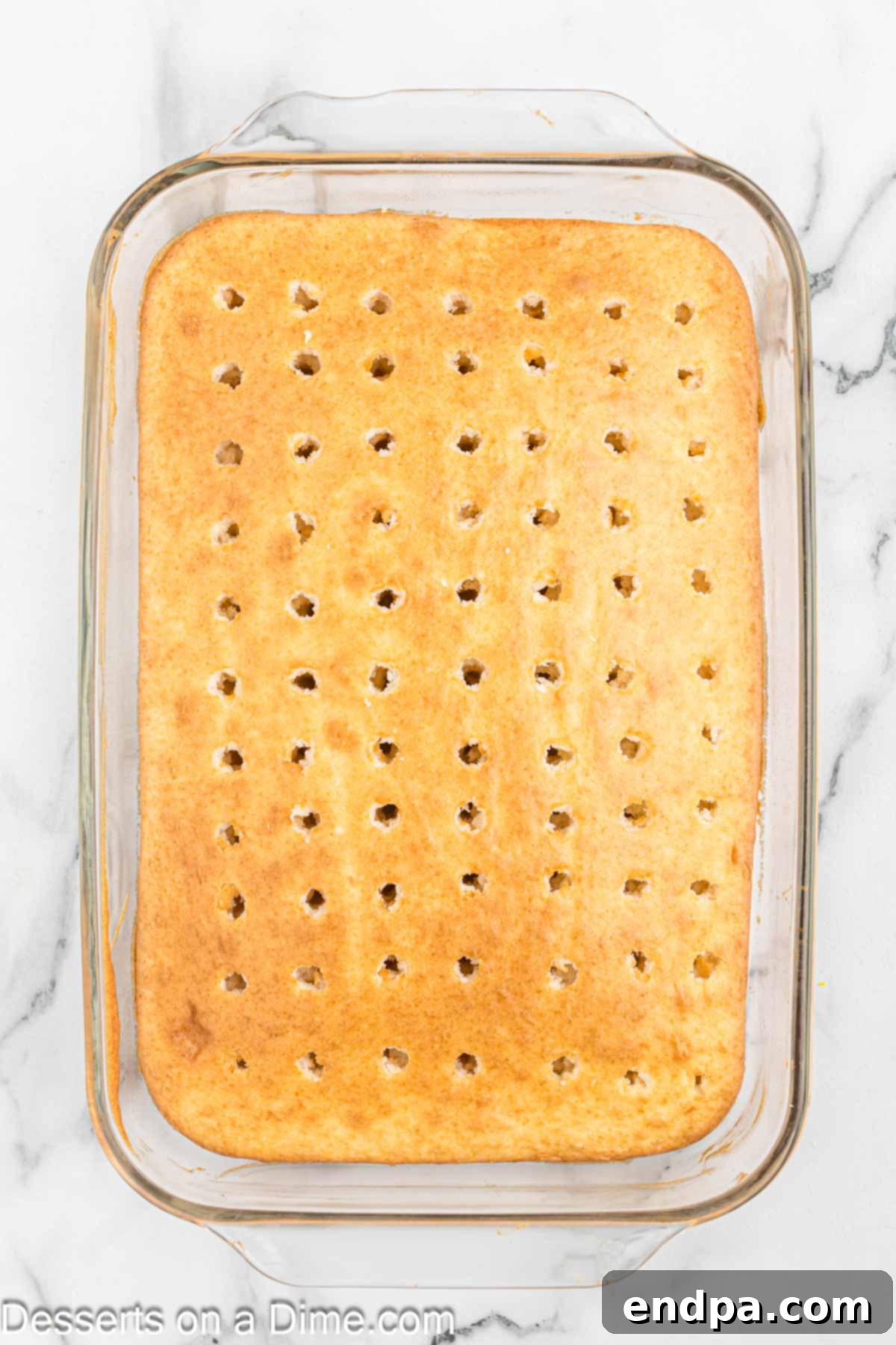 Holes poked in cake. 