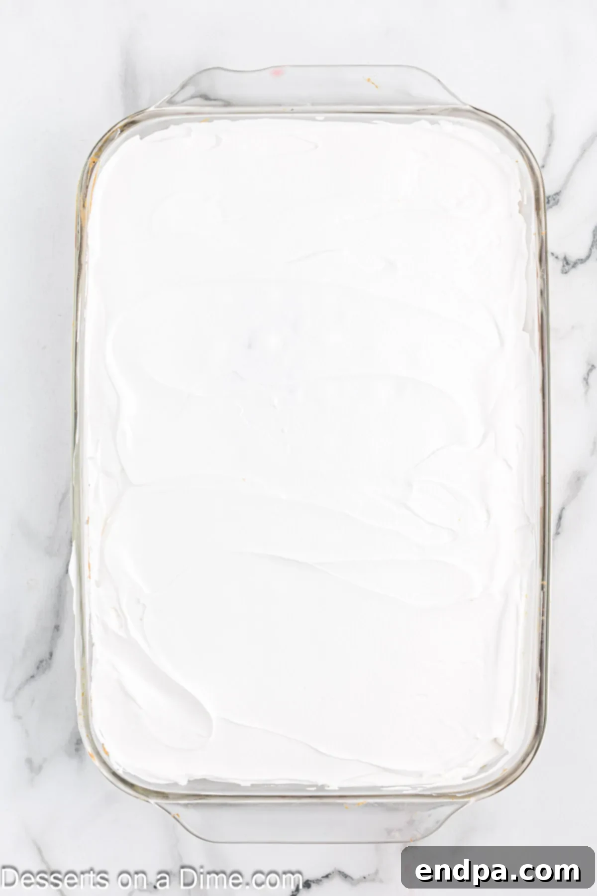 Whipped cream spread on cake. 