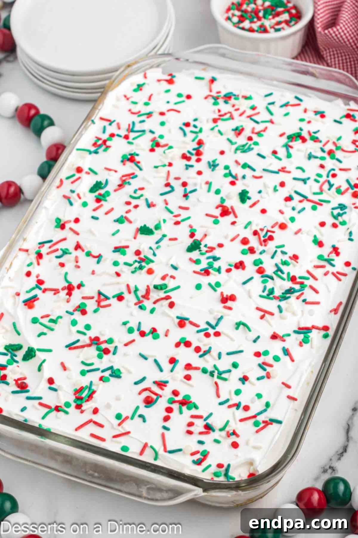 Christmas Jello Poke Cake topped with sprinkles. 