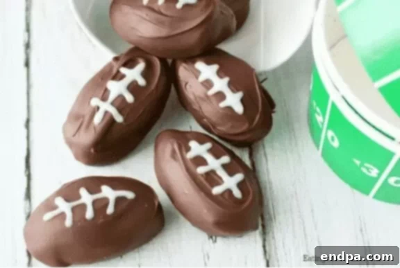 Touchdown Desserts: 55 Recipes for Your Super Bowl Party 3 Football Shaped Chocolate Peanut Butter Balls, decorated with white icing laces.