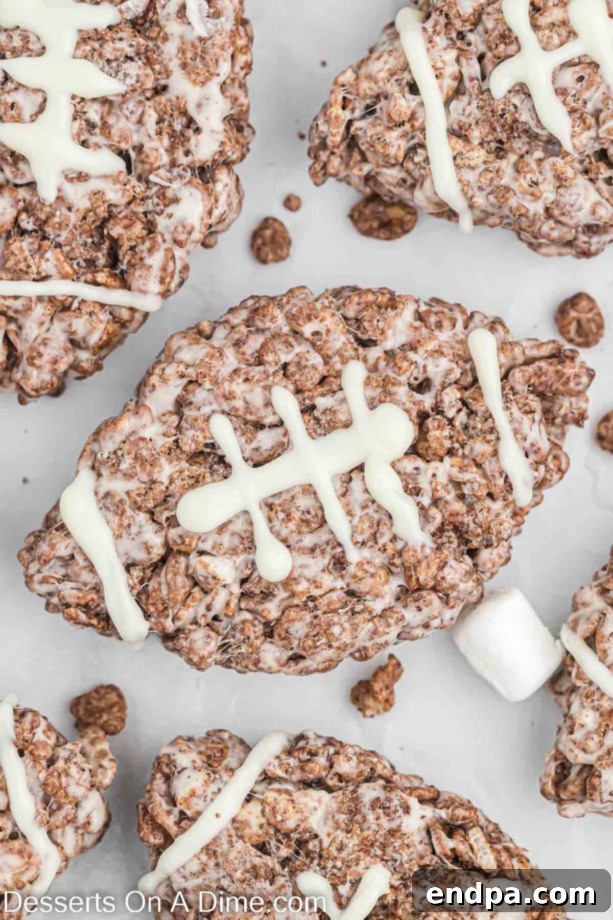 Delicious football shaped Rice Krispie treats arranged neatly on a serving tray, perfect for game day celebrations.