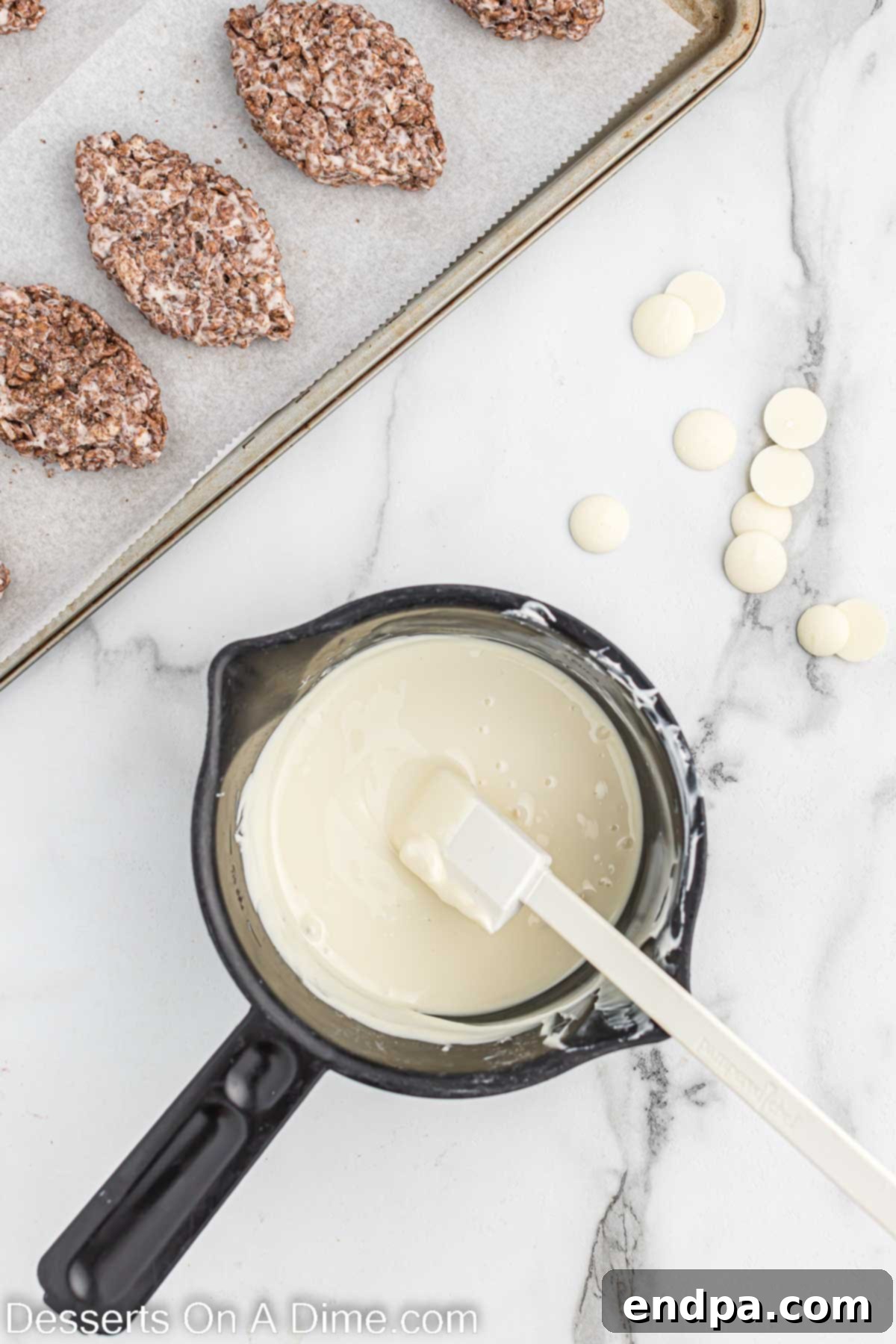 Melted white chocolate wafers in a microwave-safe bowl, ready for piping.