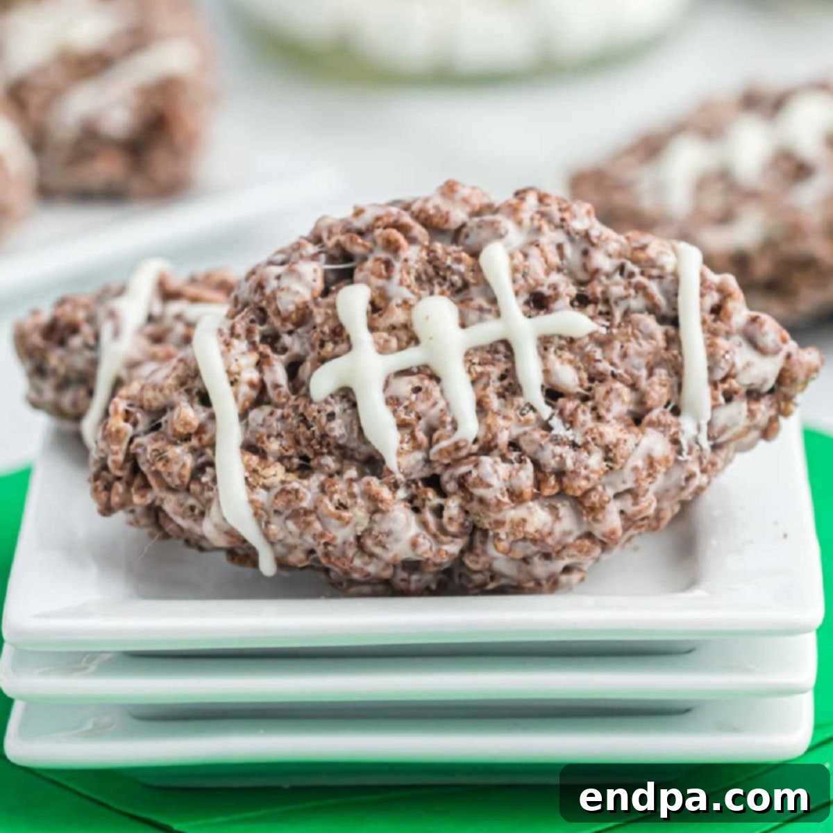 Football Rice Krispie Treats on a white background, highlighting their perfect shape and white chocolate laces.