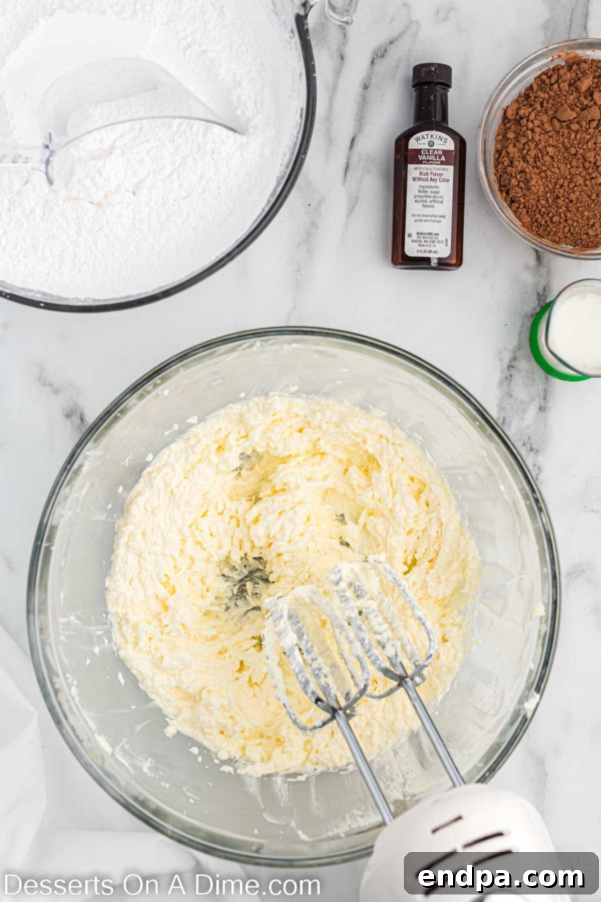 Kick-Off Cupcakes 5 Butter and shortening being creamed together in a bowl using an electric mixer.