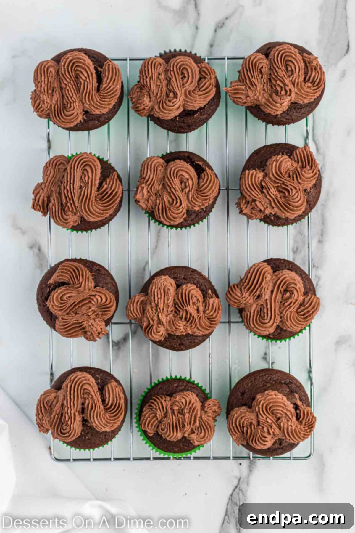 Kick-Off Cupcakes 9 Chocolate frosting being piped onto each cupcake in a swirl pattern, forming the shape of a football.