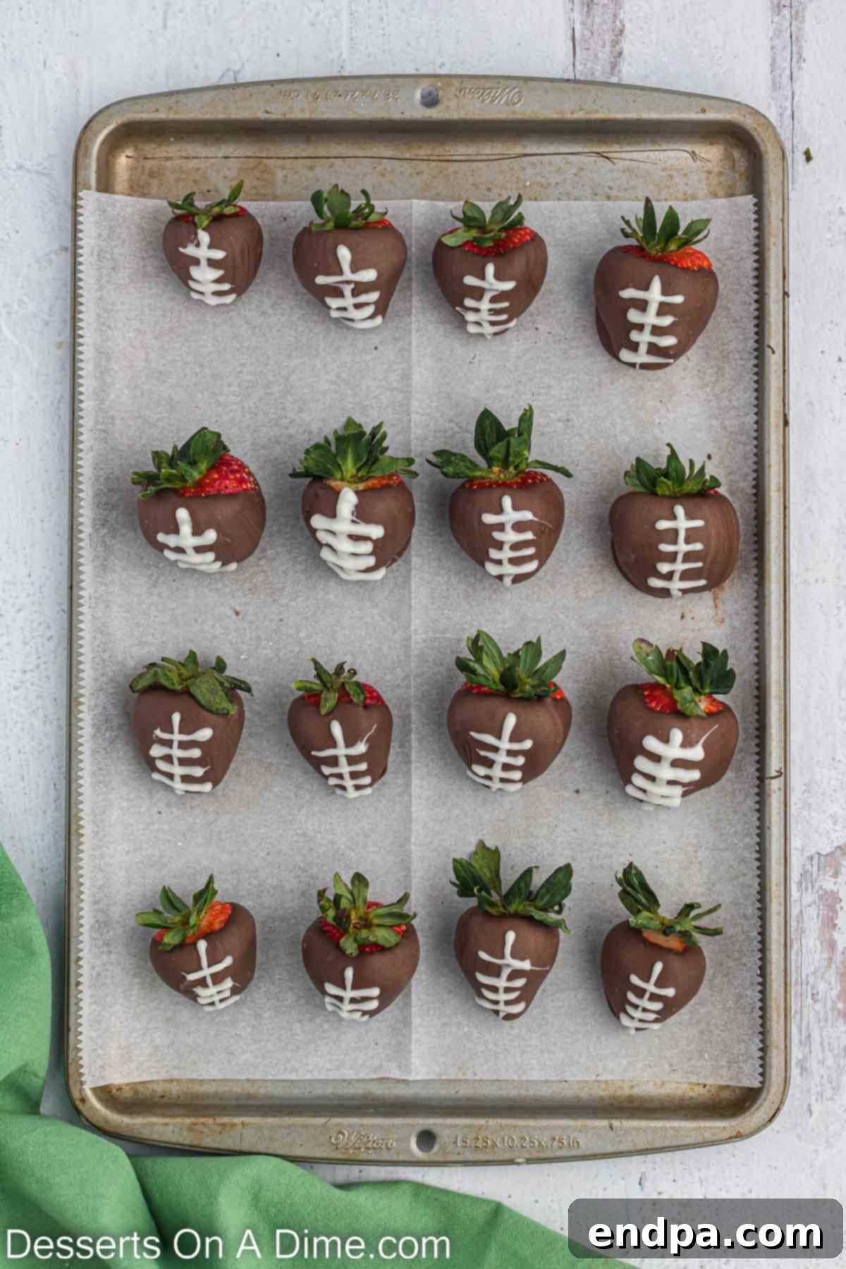 Touchdown Chocolate Strawberries 7 White chocolate piped on each strawberry to look like a football.