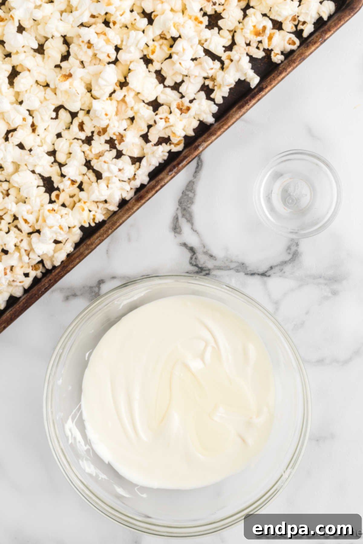 White chocolate chips melted in a microwave-safe bowl, smooth and ready to use.