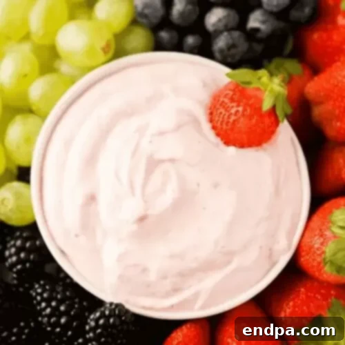 37 Luscious Strawberry Desserts 11 A bowl of creamy strawberry yogurt dip with fruit.