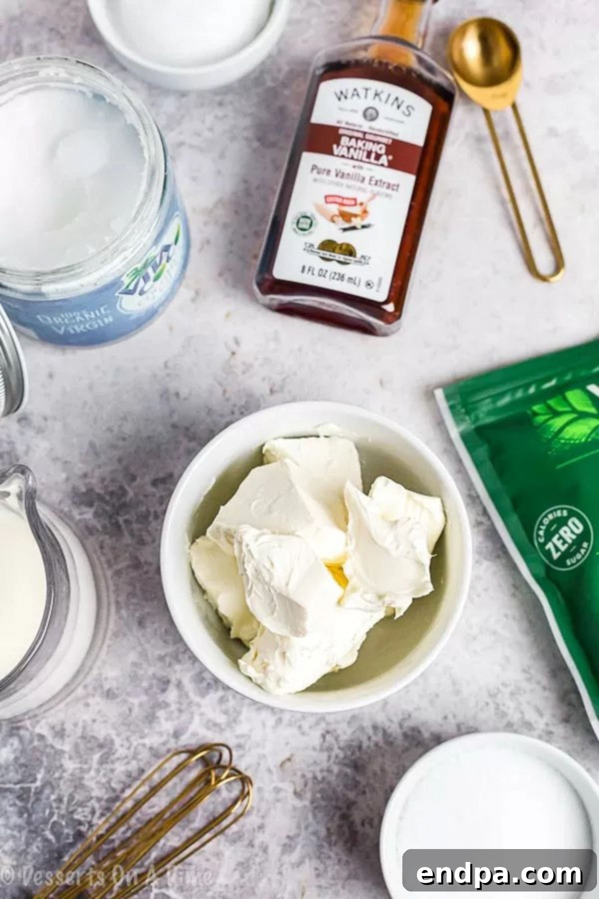 All essential ingredients laid out: softened cream cheese, butter or coconut oil, heavy cream, erythritol sweetener, vanilla extract, and grated sugar-free chocolate, ready for making Keto Cheesecake Fat Bombs.