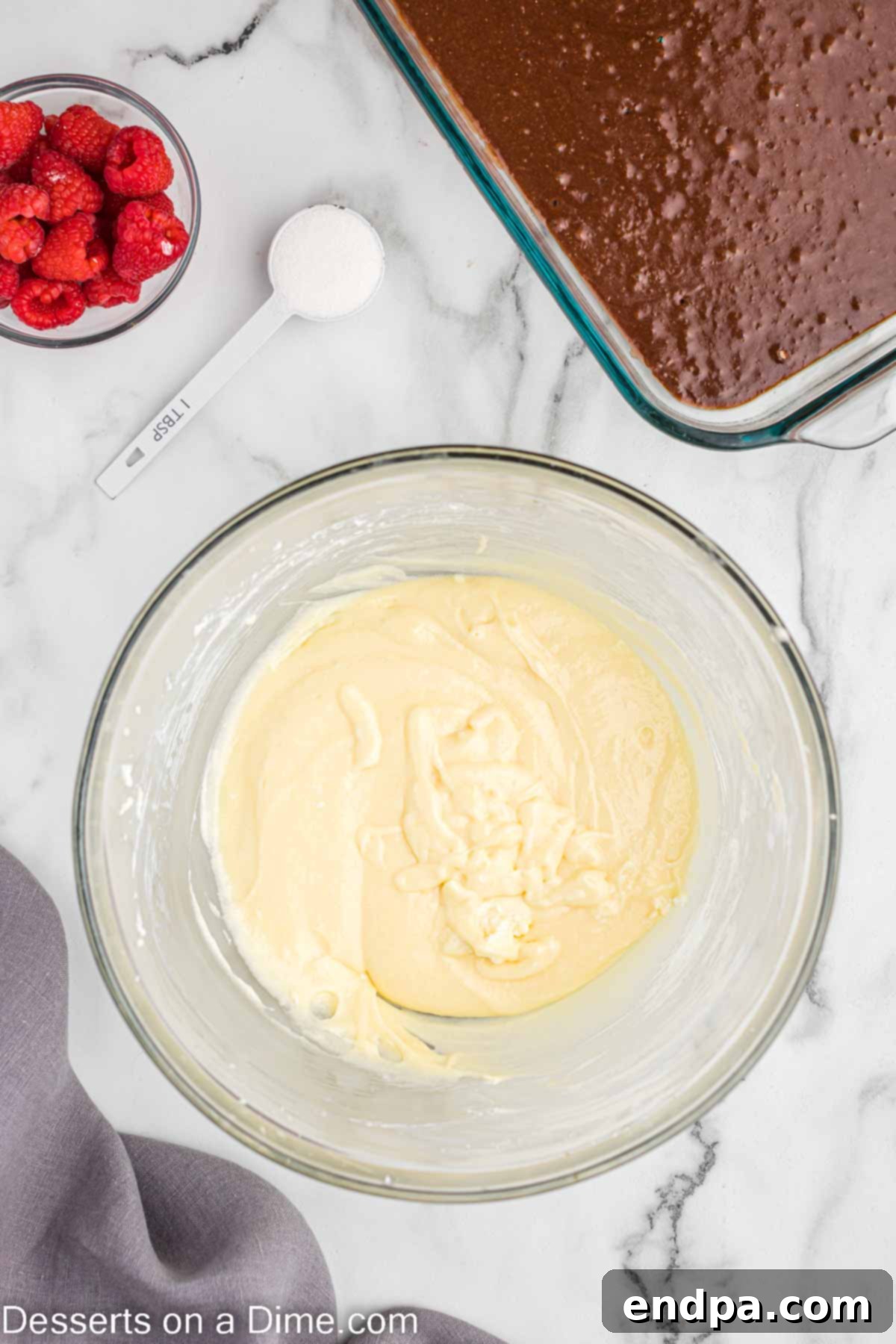 Beating cream cheese with sugar, egg, & vanilla