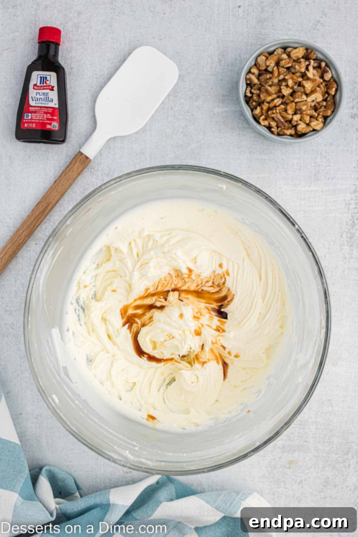 Cream cheese frosting combined in a bowl and vanilla mixed in.