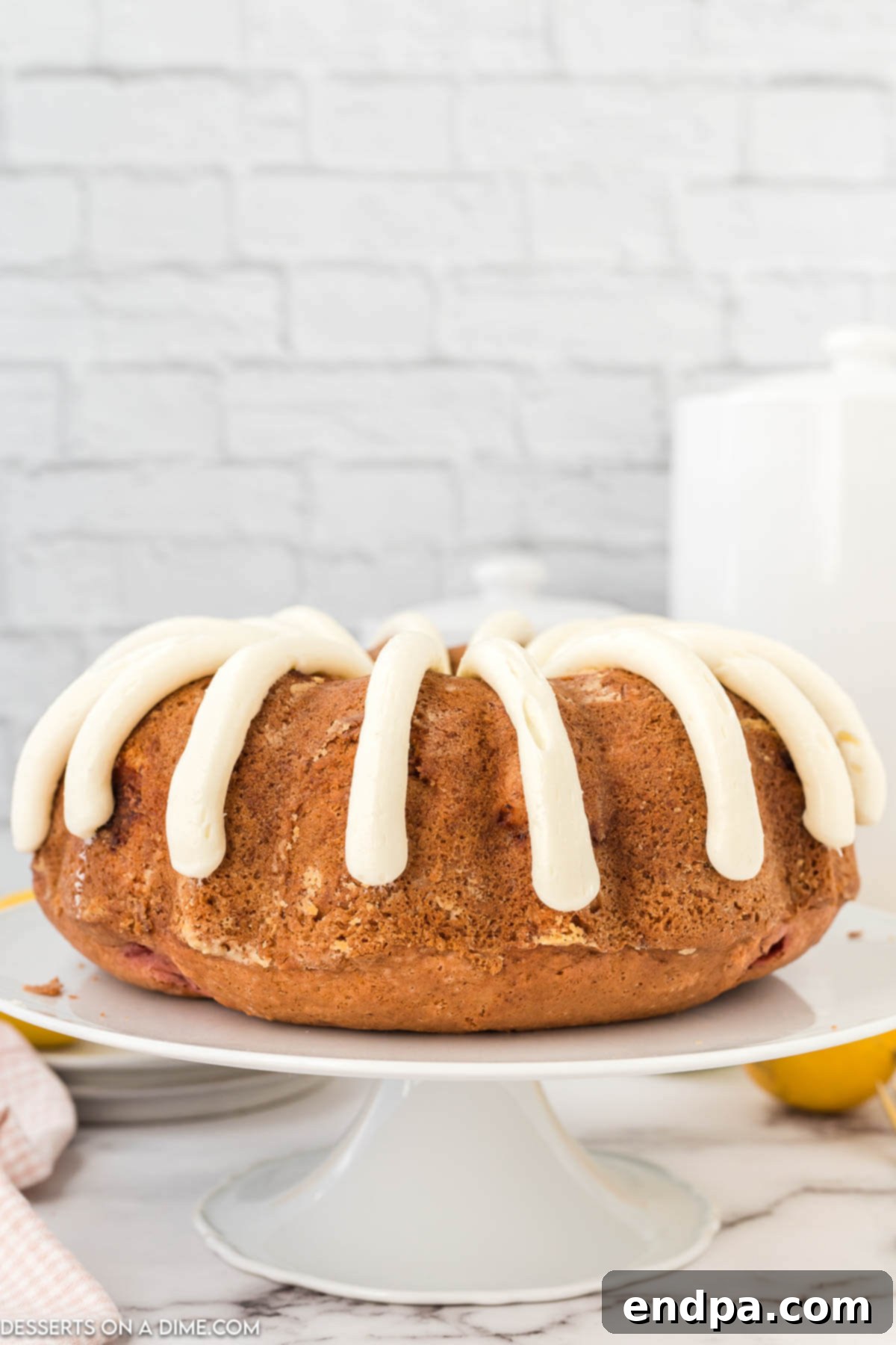 Zesty Strawberry Lemon Bundt Delight 2 Strawberry lemonade bundt cake on pedestal.